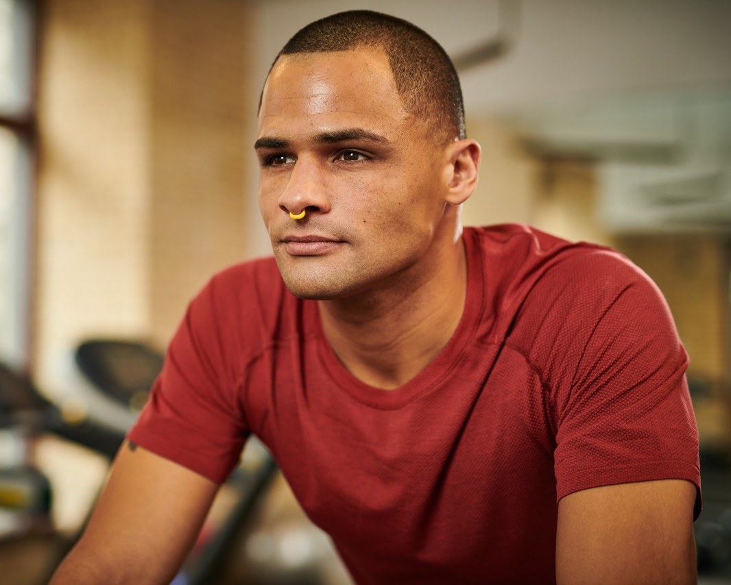 Man in a gym wearing a yellow Turbine nasal dilator